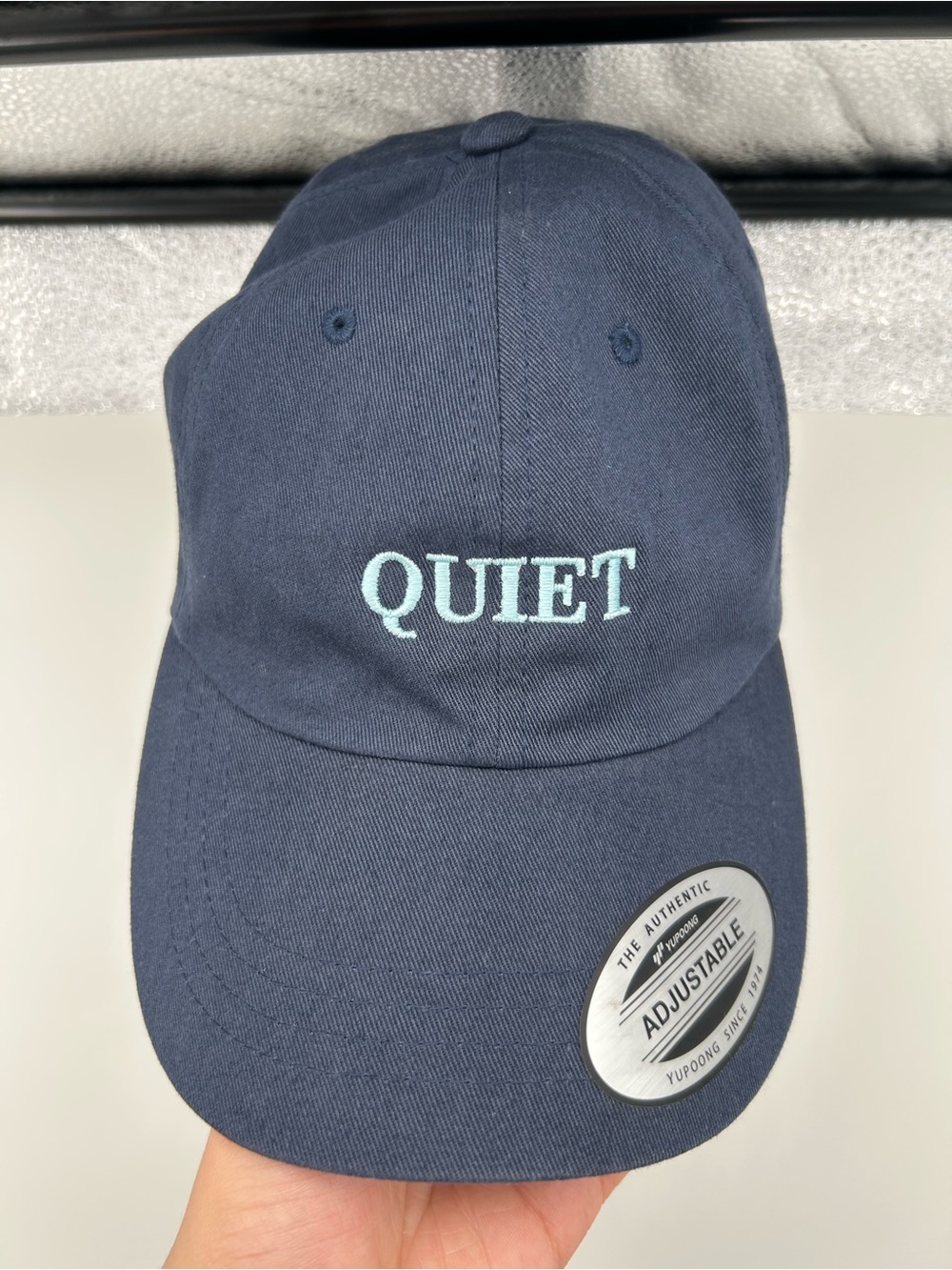 The Classic Navy Blue 'QUIET' Embroidered Baseball Cap with Light Blue Lettering
